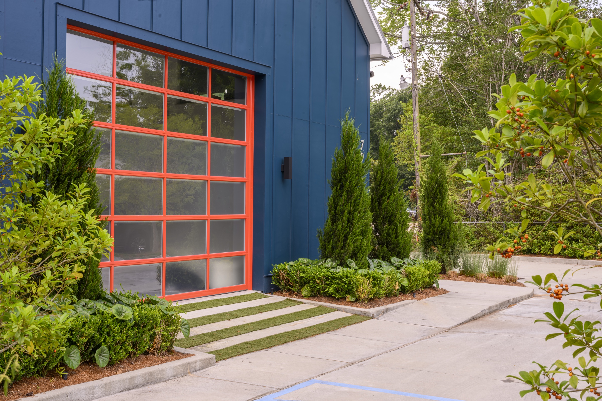 Commercial work, orange overhead door with paver path