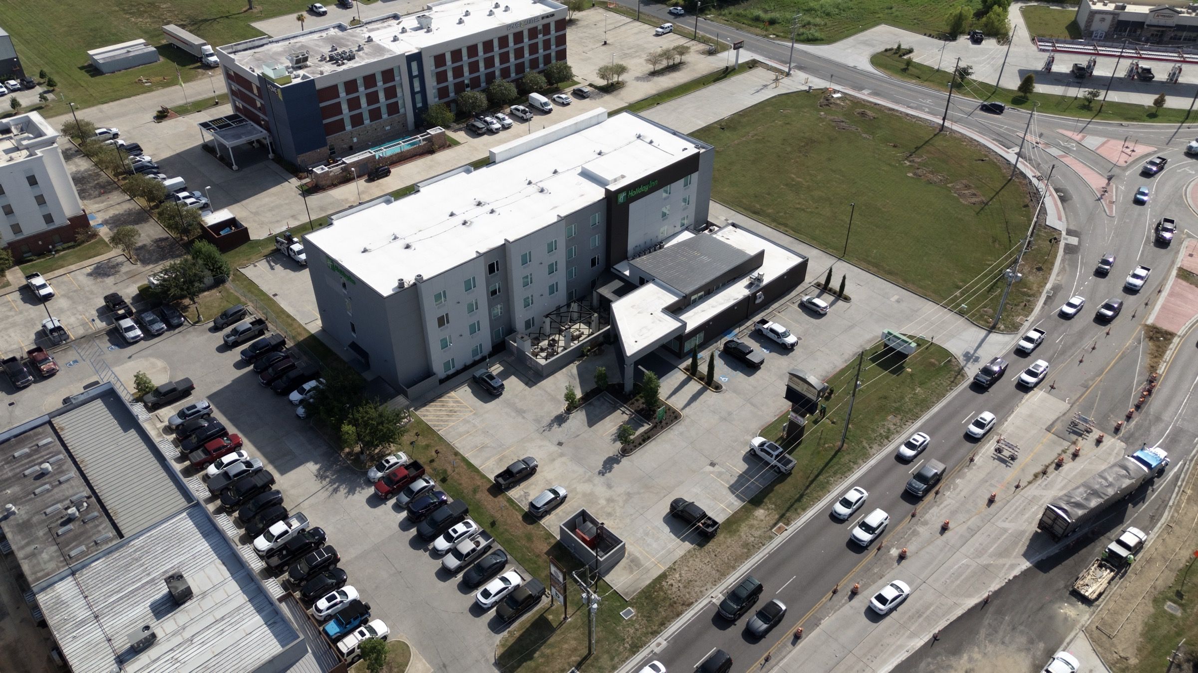Holiday Inn, aerial view of the hotel, entry drive, and parking lot plantings