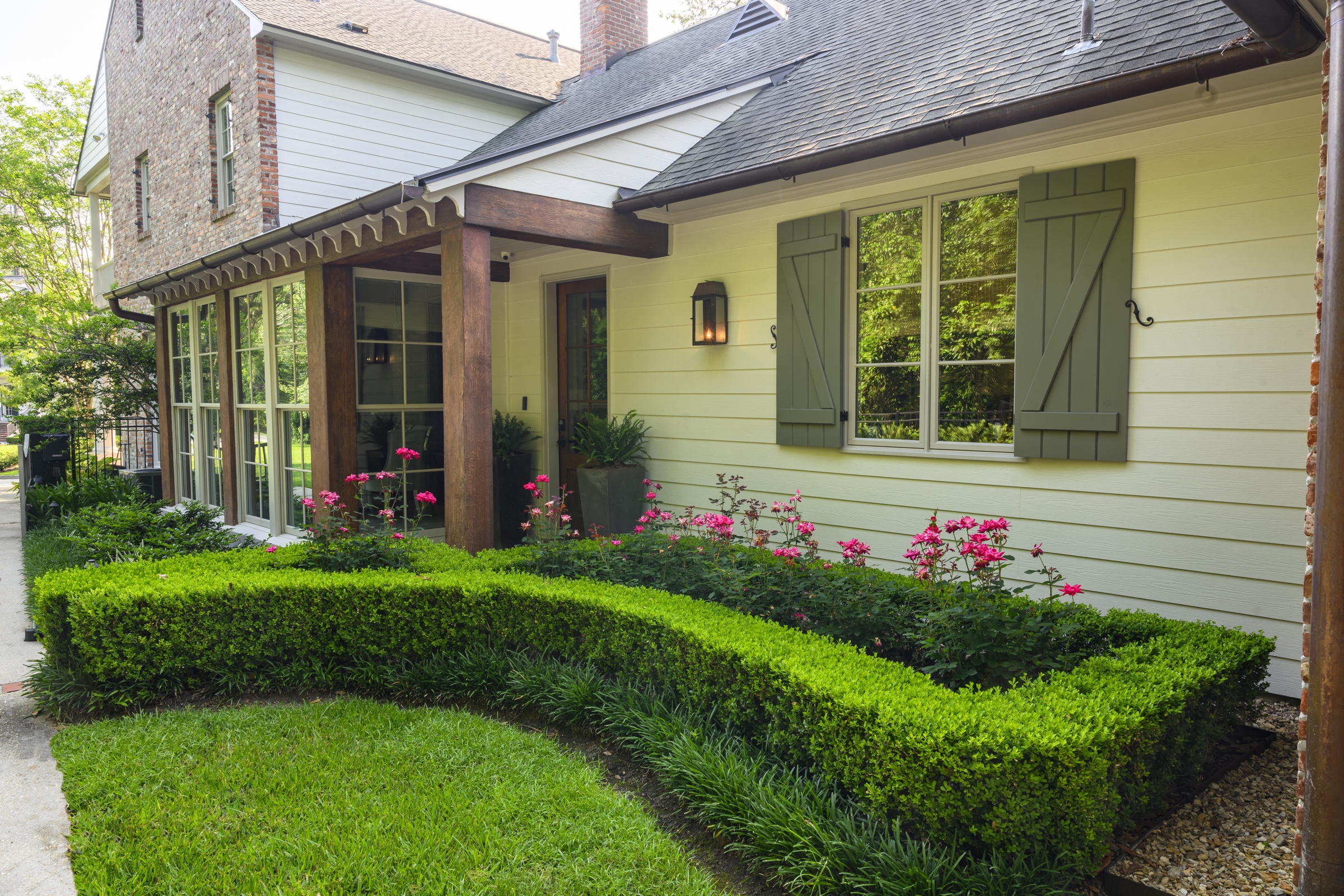 Cottage frontage with boxwood hedge and rose border