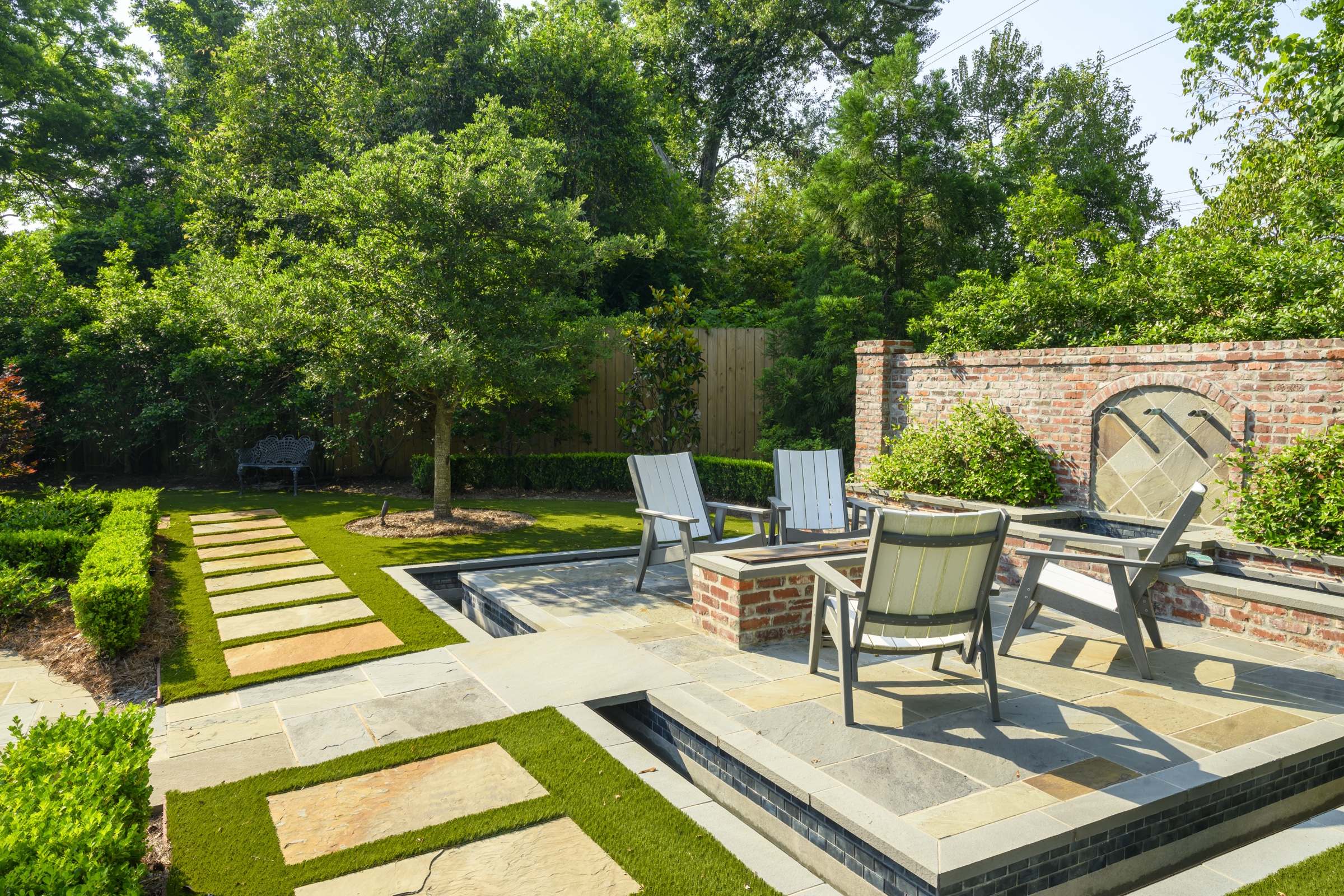 Sunken patio with brick wall and fire feature