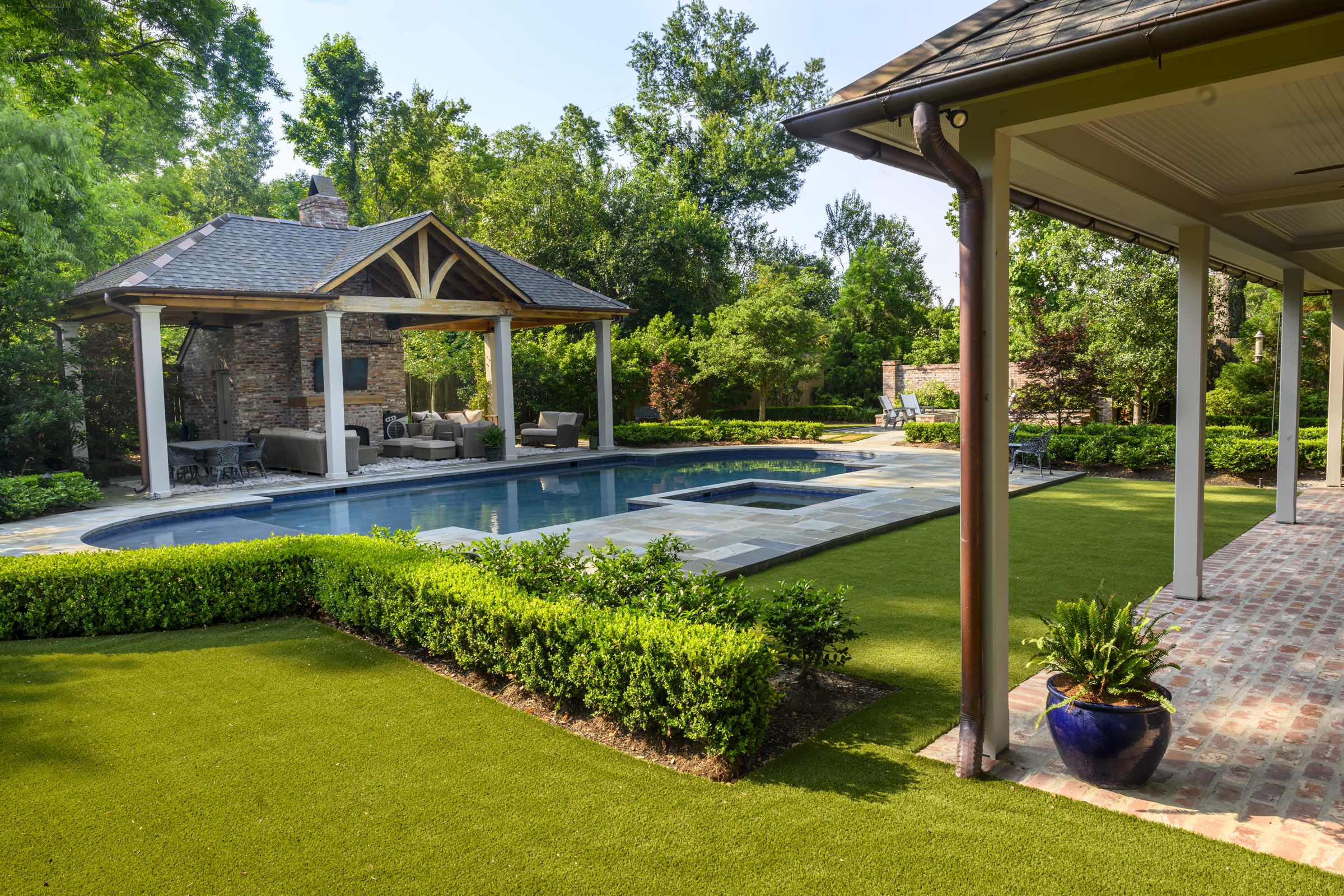 Timber pavilion and covered porch overlooking the pool