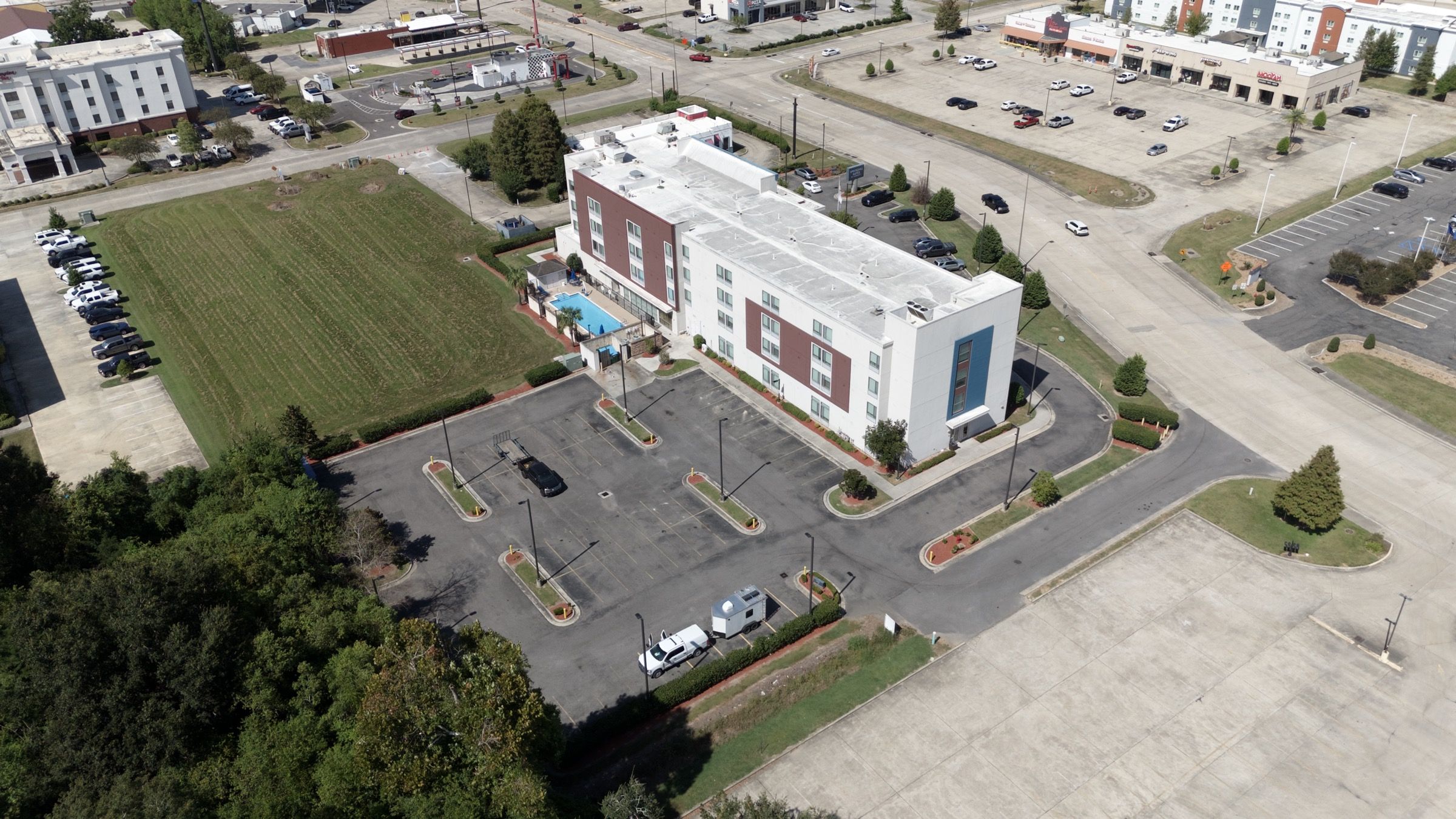 SpringHill Suites, aerial view across the site toward the lawn and beds